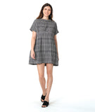 model in a black and white plaid pullover dress with short raglan sleeves, a standing portrait collar, and shaping darts along the waist