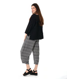 model in a 3/4 sleeve black pullover top with a black and white plaid pant with a wide leg, tapered ankle, and oversized pockets