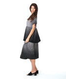 model in a black and white ombre gradient dress with a double layer skirt
