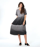 model in a black and white ombre gradient dress with a double layer skirt