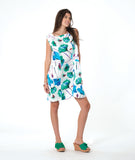 model in a white shift dress with a vibrant floral print. dress is sleeveless with a squared neckline, princess seams, and hip pockets