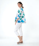 model in a white crop pant with a white pullover top with a vibrant floral print. top has 3/4 sleeves and an open, flat collar