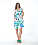 model in a white shift dress with a vibrant floral print. dress is sleeveless with a squared neckline, princess seams, and hip pockets