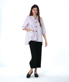 model in a wide leg black pant worn with a soft pink button down with a full body and extra large rounded pockets