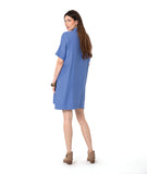 model in a periwinkle pullover dress with an open, flat collar and short sleeves