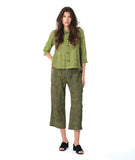model in a two piece set consisting of a green and black cargo pant and a button down blouse with 3/4 sleeves and a twin button detail
