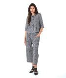 model in a two piece set consisting of a black and white cargo pant and a button down blouse with 3/4 sleeves and a twin button detail