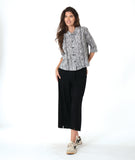 model in a wide leg black pant with a black and white striped button down blouse with 3/4 sleeves