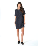 model in a grey and black pinstriped shift dress with princess seams and hip pockets