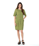 model in a green and black pinstriped shift dress with princess seams and hip pockets