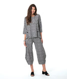 model in a barrel leg black and white striped pant, with a matching pullover top with a split at the bottom of either princess seam with a twin button detail and 3/4 sleeves