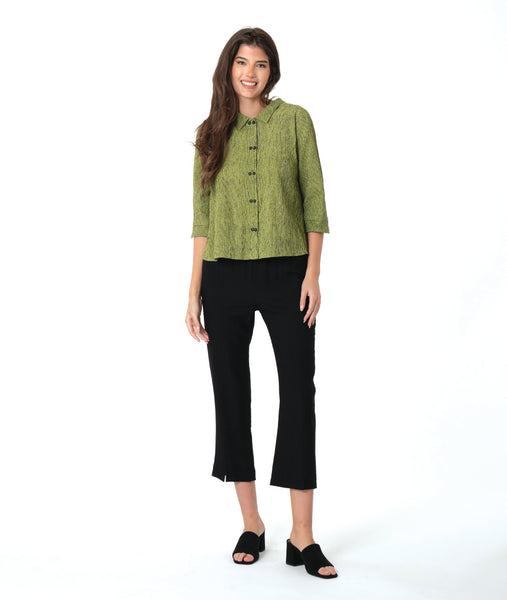 model in a slim leg black pant with a black and green striped button down blouse with 3/4 sleeves