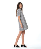 model in a black and white striped dress with short sleeves, knee length and an open, flat collar