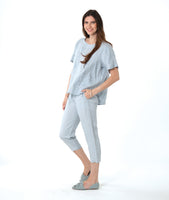model in a silver/blue slim cut crop pant, with a matching pullover boxy tee