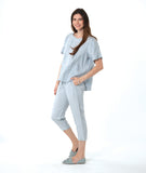 model in a silver/blue slim cut crop pant, with a matching pullover boxy tee