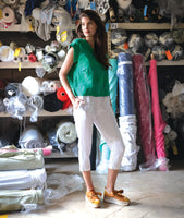 model in a slim white crop pant with a green boxy pullover tee