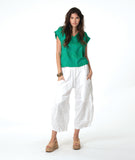 model in a wide leg white pant with a tapered ankle, worn with a green boxy pullover tee