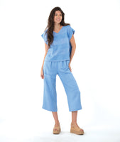 model in a blue straight leg cargo pant with a matching boxy pullover tee