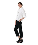model in a black pant with a white button down blouse with a double collar