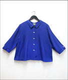 boxy electric blue button down top with a twin button detail along the front, back and sleeve cuffs