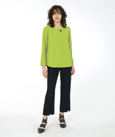 model in a lime green pullover top with a straight, slim leg pant with a split at the ankle of each leg center seam