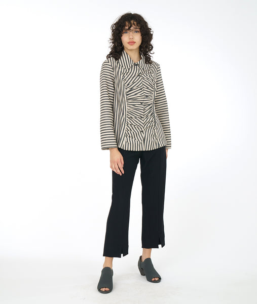 model in a slim black pant with a black and taupe stripe button down blouse with a gathered panel along the front center of the bodice