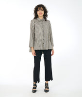 model in a slim black pant with a split at either ankle front center, worn with a taupe and black stripe button down blouse
