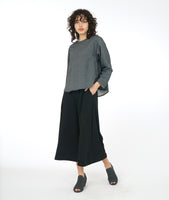 model in a wide leg black pant with a dark grey long sleeve boxy top