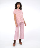 model in a red and white wide stripe top and a matching pant in pinstripe