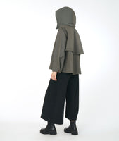 model in a wide leg cropped black pant with a grey boxy jacket with a collared hoodie and exterior pockets