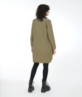 model in black leggins with a sage green tunic with long sleeves and a curved seam at either side with set in pockets