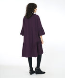 model in a boxy eggplant color dress with a flowing gathered hip and sleeve detail