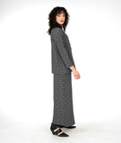 model in a leaf print wide leg pant with an overlap in the front center waist, worn with a matching button down blouse with long sleeves and a mandarin style collar