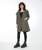 model in a mid calf grey jacket with an oversized asymmetrical collar and front placket
