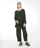 model in a wide leg distressed olive pant with a pucker at each calf, and a matching boxy top with a single pocket and a full body