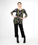 model in a slim black pant with a split at the ankle, with a green multi color line and circle print top with a hankerchief hem and 3/4 sleeves