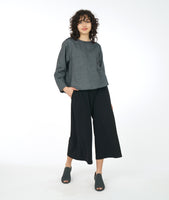 model in a wide leg black pant with a dark grey long sleeve boxy top