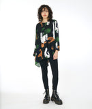 model in a black legging with a black multicolor print top with an asymmetrical body and a single cocoon sleeve