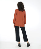 model in a slim black pant with a rust color button down blouse