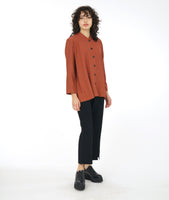 model in a slim black pant with a rust color button down blouse