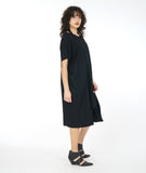 model in a black tunic dress with a convertiable strap extending from the waist, worn around the neck in a number of different styles