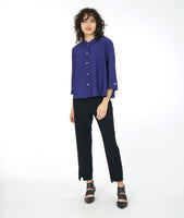 model in a wide leg black pant with an iris button down blouse with a twin button detail and a 3/4 sleeve