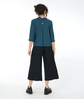 model in a wide leg black pant with a teal top