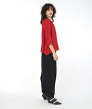 model in a red button down blouse with a flowy body and a wide leg black pant