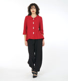 model in a red button down blouse with a flowy body and a wide leg black pant