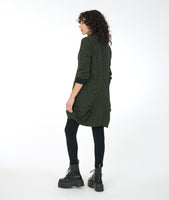 model in a green distressed tunic with long sleeves, a cowl neck, and princess seams with a pleating detail at the hips