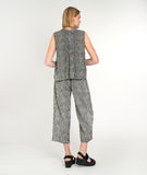 model in a black and white striped sleeveless button up blouse with a matching pant