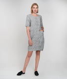 model in a black and white striped dress with hip pockets and princess seams
