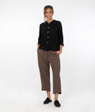 model in a wide leg brown pant with a black button down blouse with a twin button detail and a 3/4 sleeve