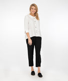 model in a white button down top with a slim leg black pant